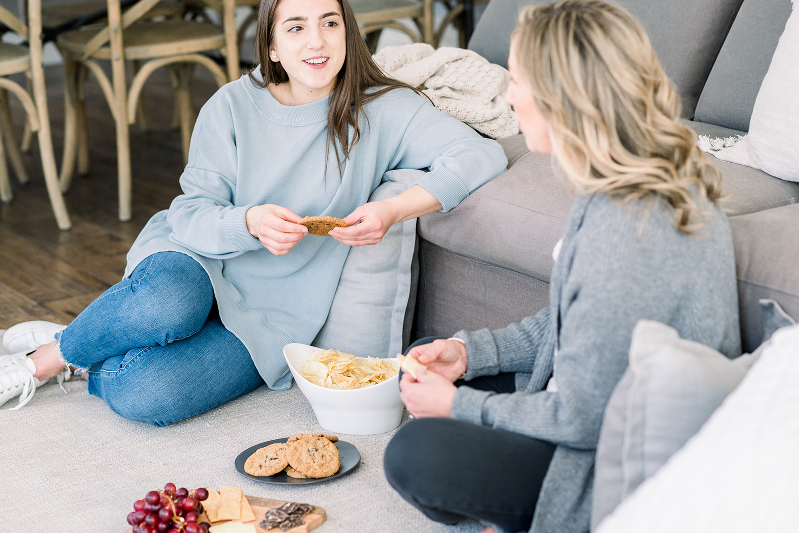 Two women eating on couch