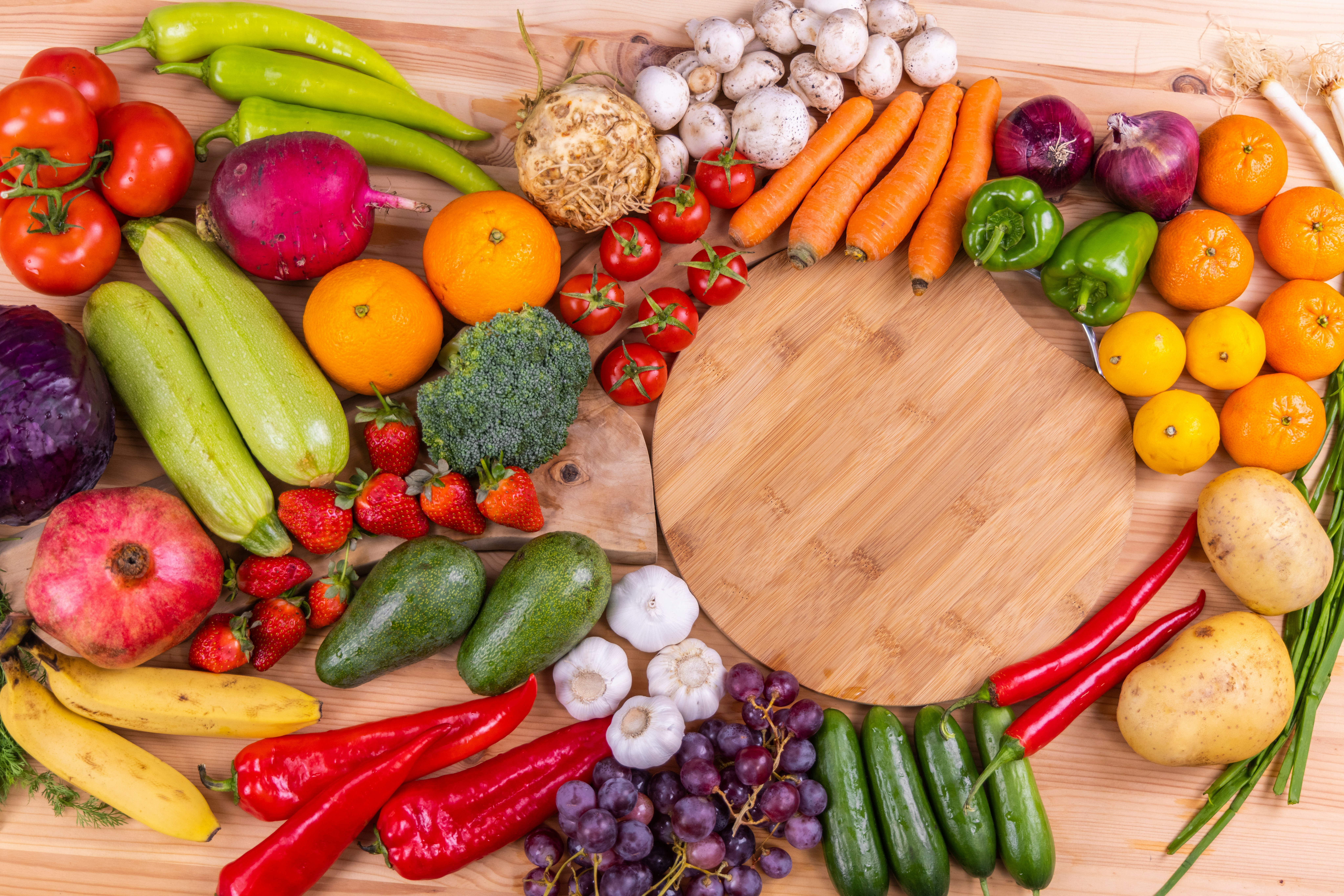 A variety of vegetables and fruits on a chopping board