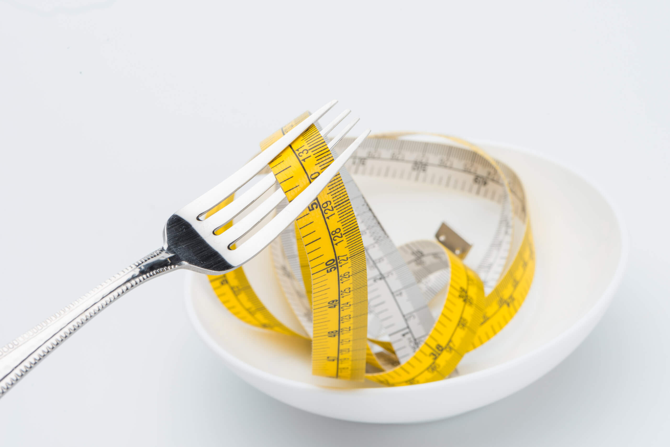 measuring-tape-on-fork-isolated-on-white-healthy